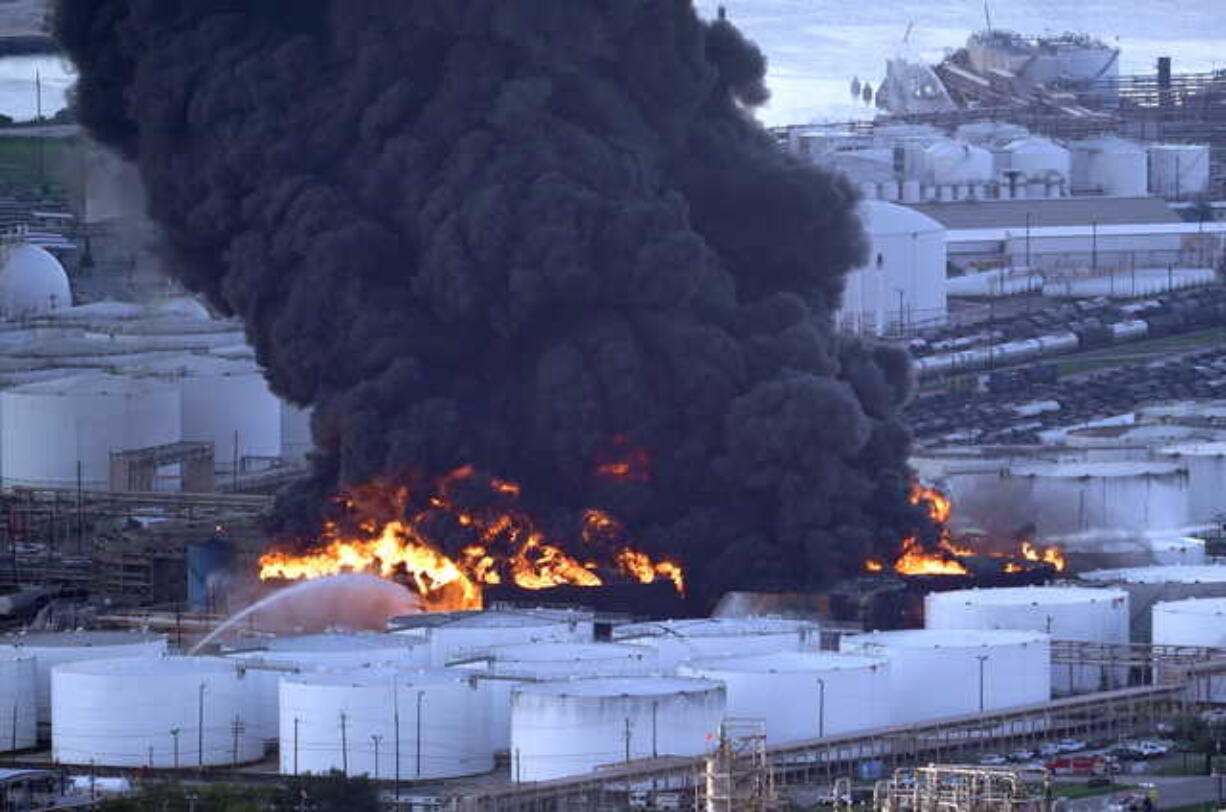 Firefighters battle a petrochemical fire at the Intercontinental Terminals Company Monday, March 18, 2019, in Deer Park, Texas. The large fire at a Houston-area petrochemicals terminal will likely burn for another two days, authorities said Monday, noting that air quality around the facility was testing within normal guidelines. (AP Photo/David J.