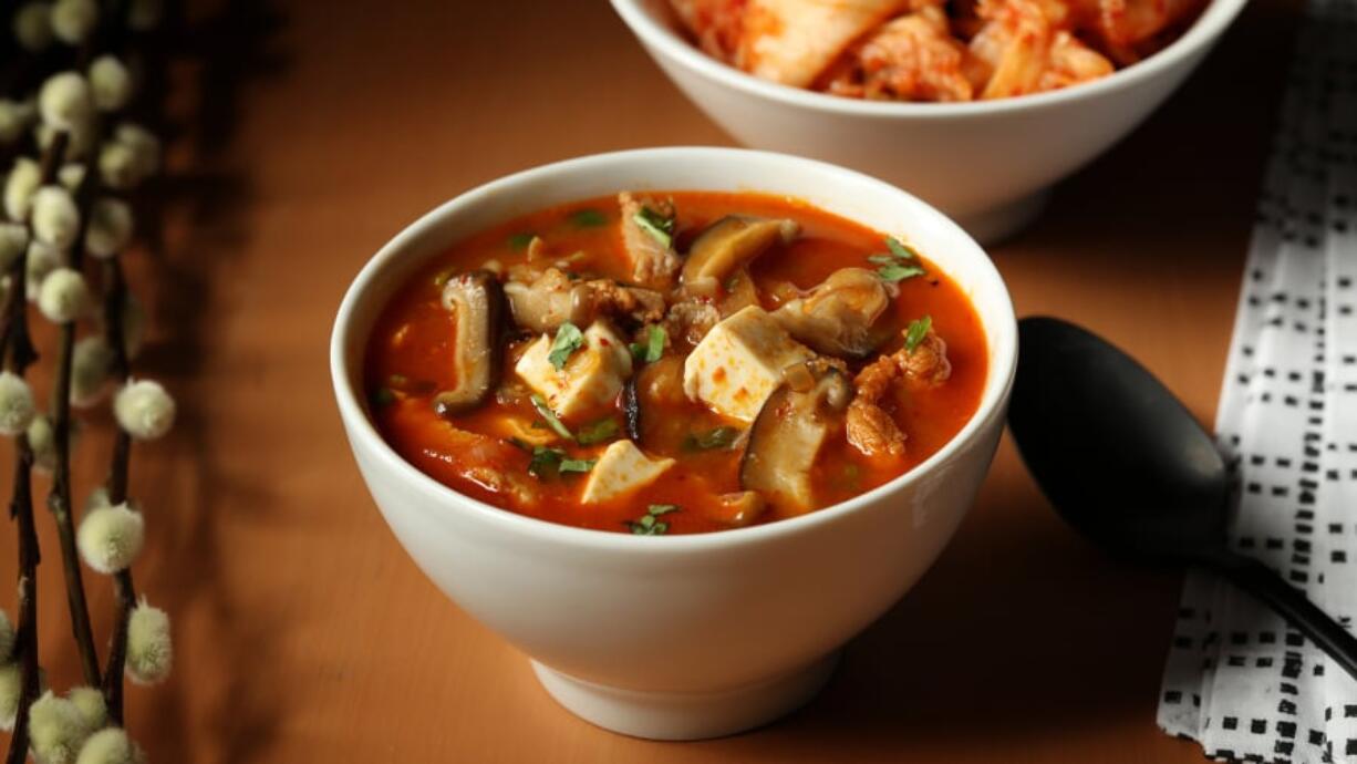 Pork and red chile kimchi stew, re-created from a favorite Korean restaurant, is built on the spicy and sweet/tart flavors of the pickled vegetable staple plus gochujang (red chile paste) and gochugaru (red chile flakes). (E.