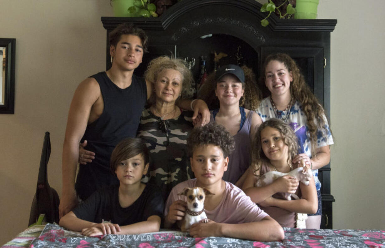 The Flores family sits for a portrait at their dining room table in Vancouver on Aug. 23, 2017. Since Ramon Flores-Garcia was deported in August 2017 to Mexico, after staying at a Motel 6 in Everett, his family has become homeless and moved to Chula Vista, Calif., to be closer to him.
