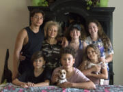 The Flores family sits for a portrait at their dining room table in Vancouver on Aug. 23, 2017. Since Ramon Flores-Garcia was deported in August 2017 to Mexico, after staying at a Motel 6 in Everett, his family has become homeless and moved to Chula Vista, Calif., to be closer to him.