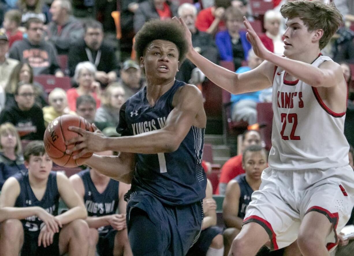 King’s Way’s Khalfani Cason (1), drives toward the hoop against King’s Knights’ Nate Kleppe (22), during the WIAA 1A boys state tournament on Friday, Mar. 1, 2019, at the Yakima Valley SunDome. King’s Way Knights defeated King’s Knights 43-42.