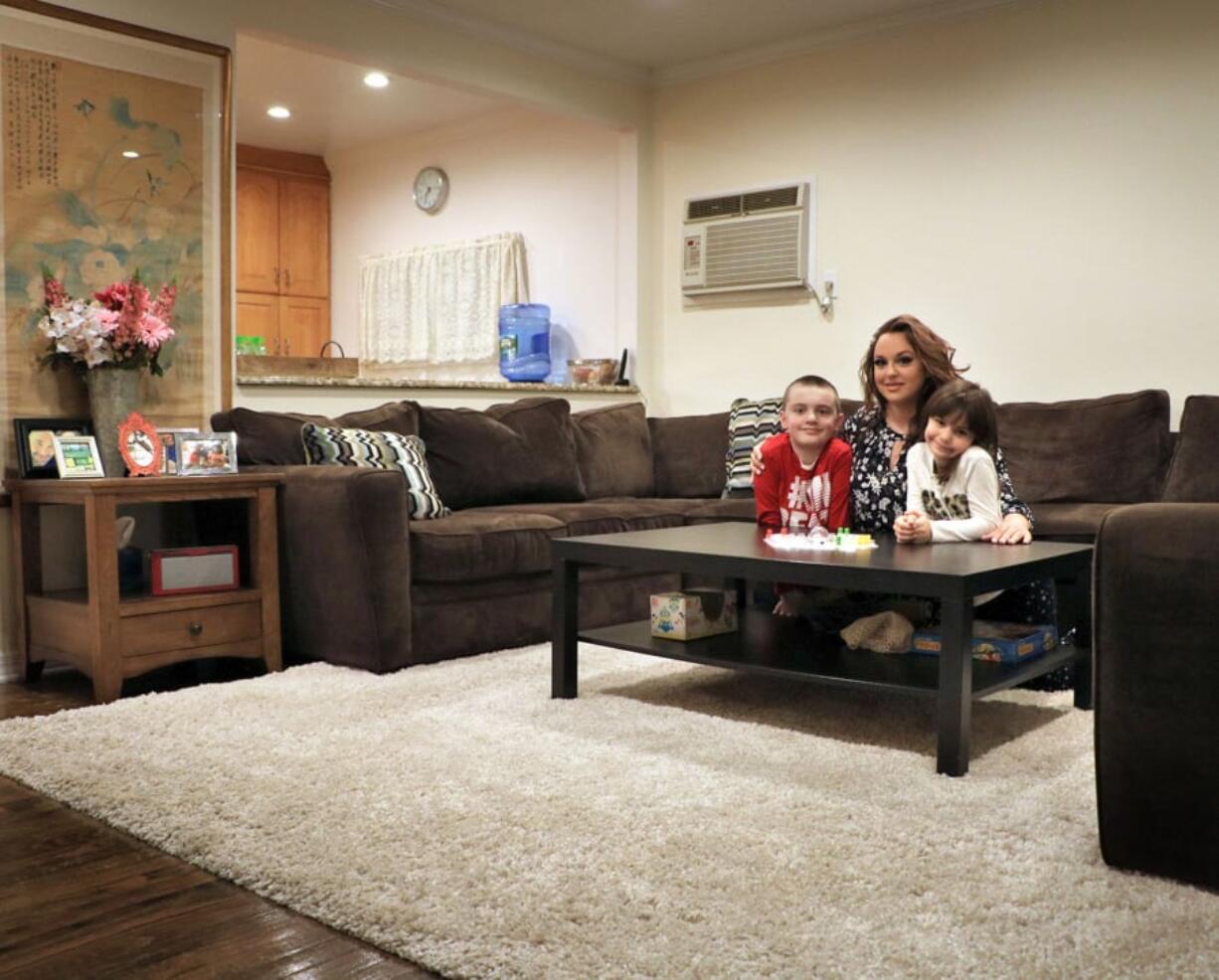 Michelle Bajada and her children, Rocco Nicolosi, 11, and Mary Anna Nicolosi, 7, secured a rug for the living room of their Floral Park, N.Y., home through a Buy Nothing group.