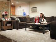 Michelle Bajada and her children, Rocco Nicolosi, 11, and Mary Anna Nicolosi, 7, secured a rug for the living room of their Floral Park, N.Y., home through a Buy Nothing group.