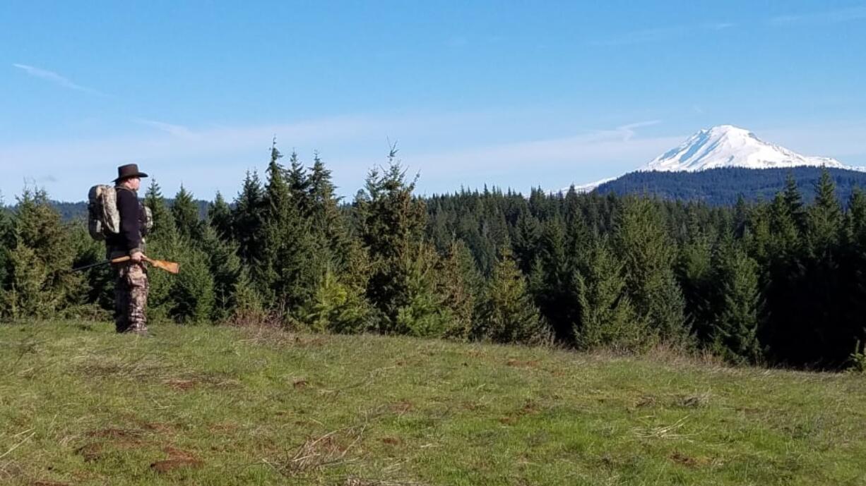 Buzz Ramsey of Lyle, Washington scans the hillsides for wild turkeys recently with a snow-capped Mount Adams in the distance. The spring hunting season for turkeys began last Monday under sunny skies, and will run until May 31.