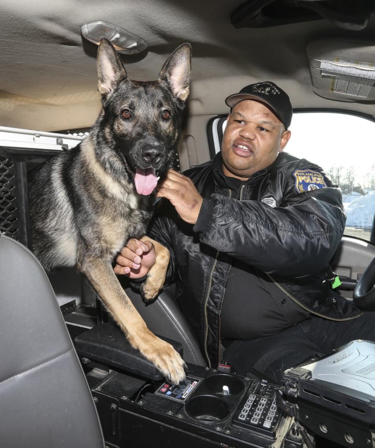 Philadelphia police Officer Alvin Outlaw and his K-9 partner, Thor, on Feb. 14, 2014. Thor is losing the use of his back legs and will soon receive a wheelchair.