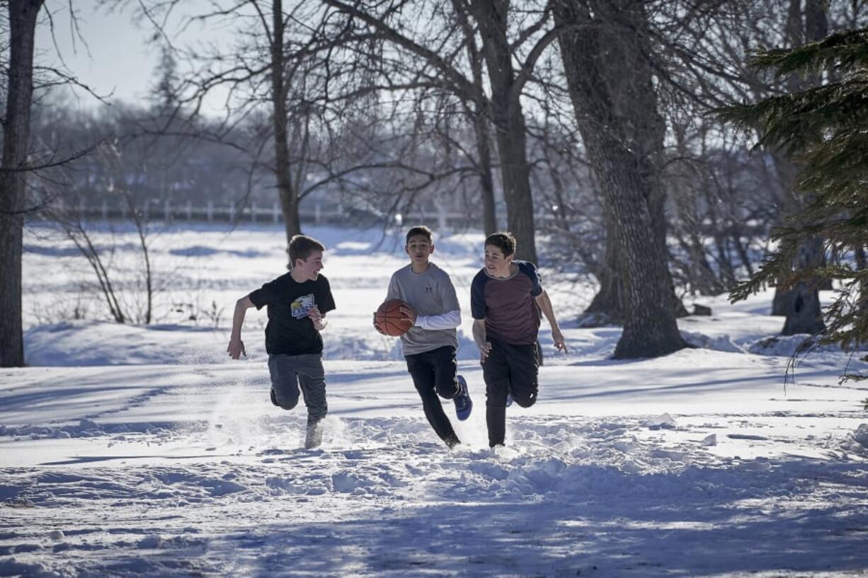 Isaac Kragten, left, and Nikolas Dukic, right, appear alongside Marcel Ruiz, who stars as a typical Missouri teen who survives after being submerged in an icy lake in “Breakthrough.” MUST CREDIT: Allen Fraser, Twentieth Century Fox