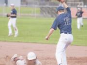 Skyview’s Titus Oien stretches out to record a game-ending double play as Battle Ground’s Sean Pearce slides back into first base in a 4A Greater St. Helens League baseball game Thursday in Battle Ground. Skyview won 12-2.