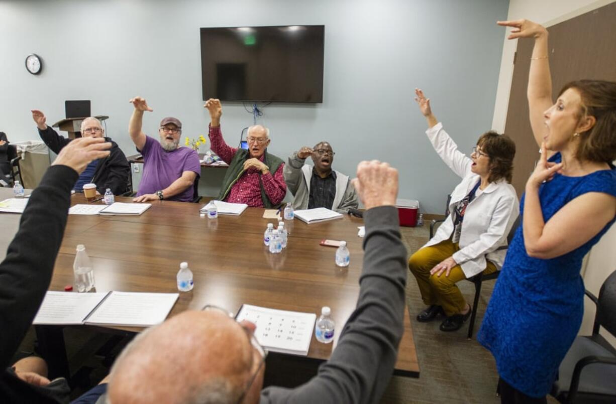 Samantha Elandary, right, the founder and CEO of the Parkinson Voice Project, and Lynn Gallandt, a speech therapist with the Los Alamitos Medical Center, lead a therapy session of Parkinson’s disease patients March 13 at the center in Los Alamitos, Calif.