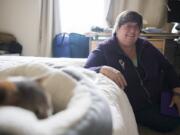 Patt Doyle, owner of Pampurred Pet Care, sits with the cat Posha during a house visit. She’s been watching the cat for a few years, Doyle said. She doesn’t agree with people who believe that cats are independent and don’t need much tending to. ‘A lot of people say that but cats are predators and they tend to hide their illnesses. And, they are pets, they are used to us being around,’ she said.