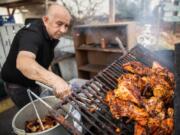 Juan Olguin Sr. grills chicken at Don Juan Corner Cafe, the restaurant he and his son Juan Olguin Jr. own and operate together in Vancouver. The elder Olguin starts preparing the weekend specials like pollo asado al carbon at 1 a.m.