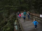 Shannon Steeves of Vancouver, center, walks across the bridge at Moulton Falls Regional Park last week with her friends and their children. Clark County opted not to install fencing on the bridge after video of Jordan Holgerson of Kalama being pushed off went viral in August 2018.