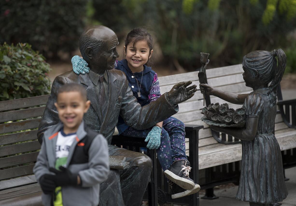 Kingston Cason, 4, foreground, of the Boys & Girls Clubs of Southwest Washington's Hope Team enjoys some down time at Esther Short Park with Kimiyo Tubania, 7, late Tuesday morning. The pair were among 20 local volunteers from the Hope Team who came out to clean rubbish from the downtown Vancouver park.