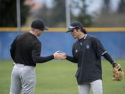 Teammates Connor Wojahn, left, and Kai Perreira of Clark College, facing, encourage each other during practice at Kindsfather Field.