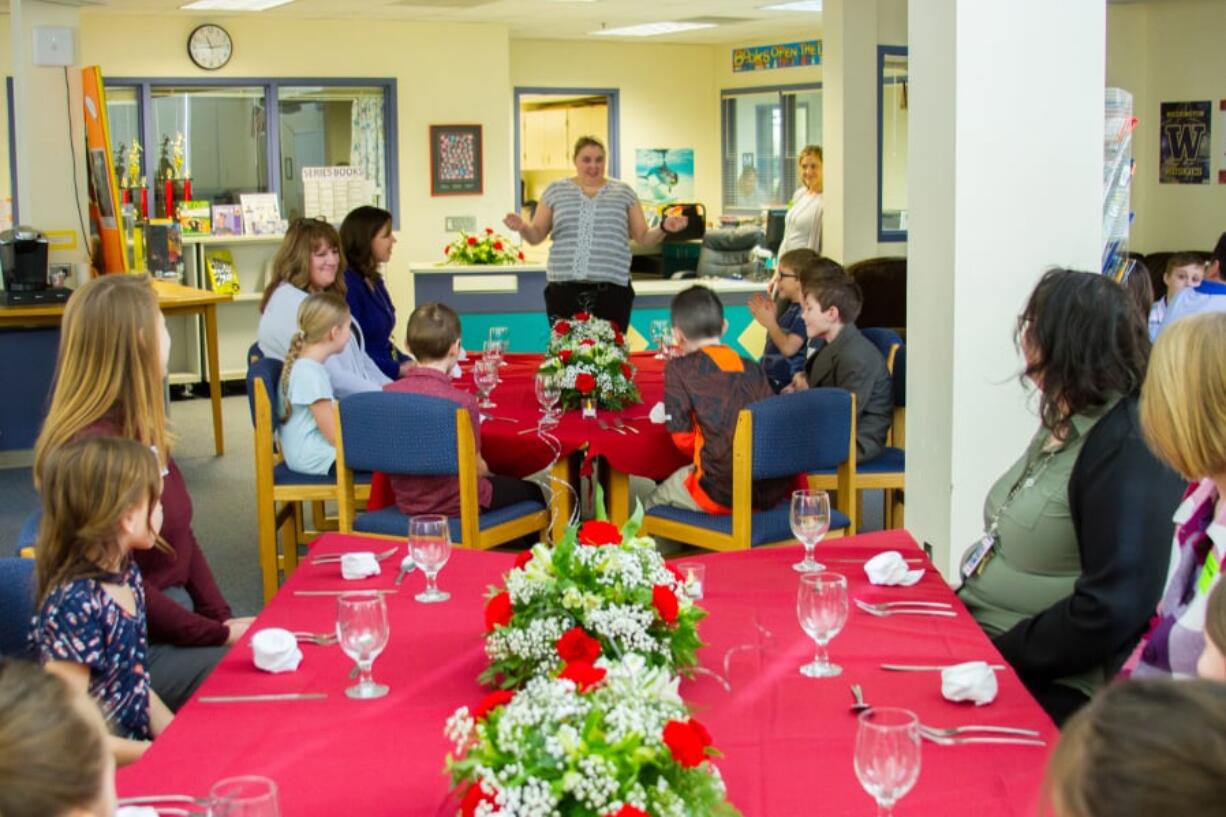 Woodland: Laura Perry, head of Nutrition Services for Woodland Public Schools, talking to students and parents about table manners prior to a fine-dining event at Woodland Intermediate School.