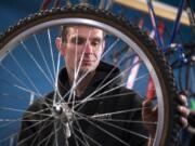 Kelly Childress of Vancouver changes out his tires at Bike Clark County's Community Hub bike shop on Main St. in Vancouver on Thursday afternoon, April 4, 2019. The non-profit opened up shop in Uptown Village about two years ago, but the organization has been running for about eight years. The shop offers a work station for the community to use. Childress said he stops by the shop often to work on his bike or check out new and used parts. "It has everything you need," he said.