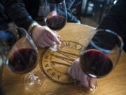 Attendees at the industry preview of Maryhill Winery Vancouver Tasting Room sit around a small table April 11.