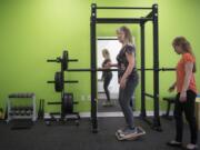 Cheryl Carroll of Vancouver performs a strengthening exercise while physical therapist Adria Biasi supervises at the Vancouver Therapydia, a physical therapy and wellness clinic that specializes in one-on-one appointments. “I get to be with them through the manual therapy, through the exercises, watching every move that they are making and correcting through that,” Biasi said of clients.