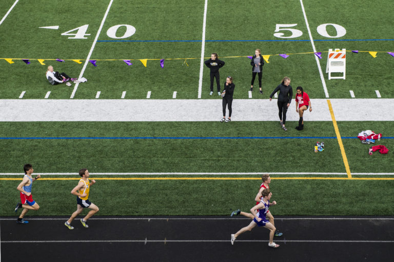 Runners compete in the Boys 1600 Meter during the John Ingram Twilight Track Meet at Columbia River High School on Friday night, April 12, 2019.