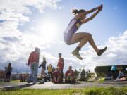 Columbia River’s Giovanna Rhoads completes the triple jump during the John Ingram Twilight Track Meet at Columbia River High School on Friday night, April 12, 2019.