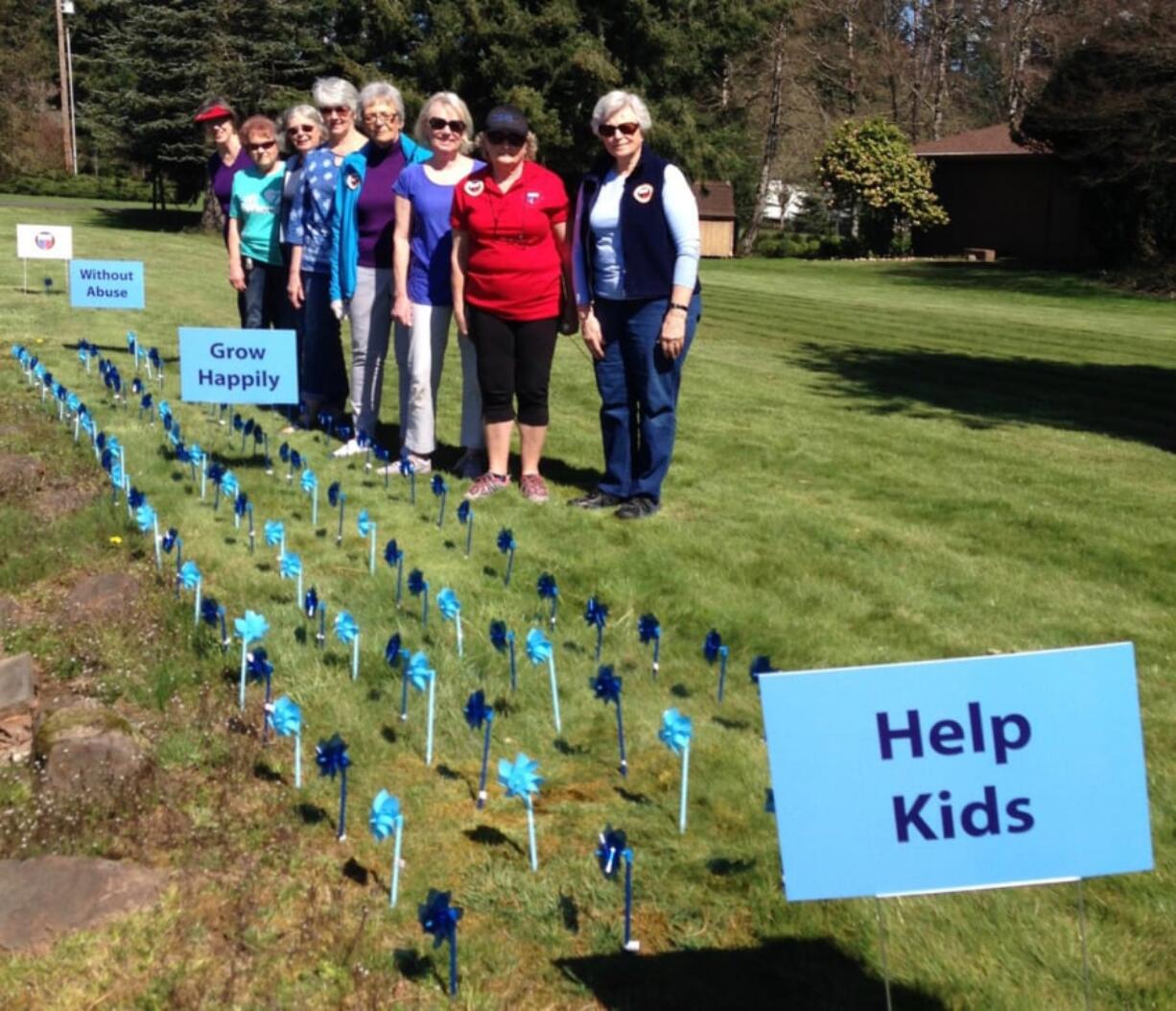 Battle Ground: Members from the Battle Ground chapter of General Federation of Women’s Clubs planted 108 pinwheels in a garden for awareness of child abuse. From left: Johanna Hyatt, Nancy Lee, Valerie Huey, Wendy McDaniel, Gloria Walck, Paulette Stinson, Marla Polos and Mary Lee Miller, president of the club.