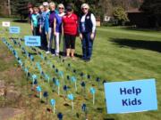 Battle Ground: Members from the Battle Ground chapter of General Federation of Women’s Clubs planted 108 pinwheels in a garden for awareness of child abuse. From left: Johanna Hyatt, Nancy Lee, Valerie Huey, Wendy McDaniel, Gloria Walck, Paulette Stinson, Marla Polos and Mary Lee Miller, president of the club.