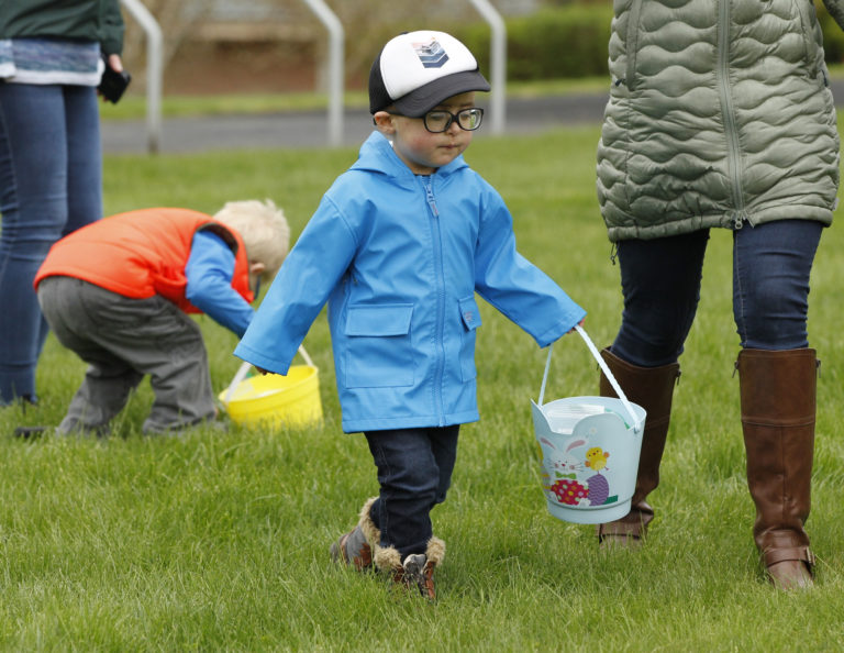 Carson Monteleone, 3, of Portland, enjoys the Washington School for the Blind Easter egg hunt for visually-impaired kids.(Steve Dipaola for the Columbian)