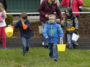 Children hunt for beeping Easter eggs at the Washington State School for the Blind on Saturday morning. The Easter egg hunt used beeping eggs, for visually impaired kids, but their sighted siblings could join in.