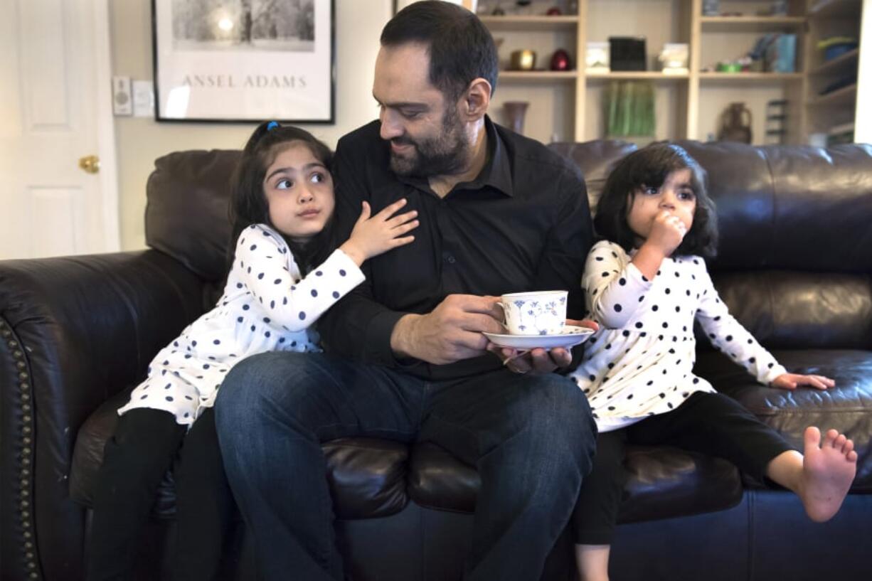 Sana Mir, 4, from left, tries to get another sip of her dad’s tea, as Ahsan Mir, 50, and Asiya Mir, 2, watch a show after dinner at their Vancouver home. Ahsan was diagnosed with kidney failure about eight years ago, but he ignored his diagnosis until recently. Now he’s trying to seek help through a kidney transplant.