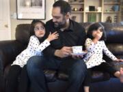 Sana Mir, 4, from left, tries to get another sip of her dad’s tea, as Ahsan Mir, 50, and Asiya Mir, 2, watch a show after dinner at their Vancouver home. Ahsan was diagnosed with kidney failure about eight years ago, but he ignored his diagnosis until recently. Now he’s trying to seek help through a kidney transplant.