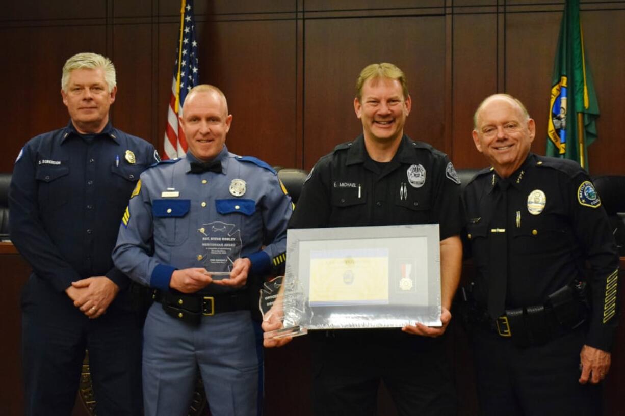 From left to right: Fire District 3 Chief Scott Sorenson, Washington State Patrol Sgt. Stephen Robley, Battle Ground police officer Ed Michael and Police Chief Bob Richardson during a recent awards ceremony.