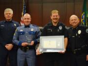 From left to right: Fire District 3 Chief Scott Sorenson, Washington State Patrol Sgt. Stephen Robley, Battle Ground police officer Ed Michael and Police Chief Bob Richardson during a recent awards ceremony.