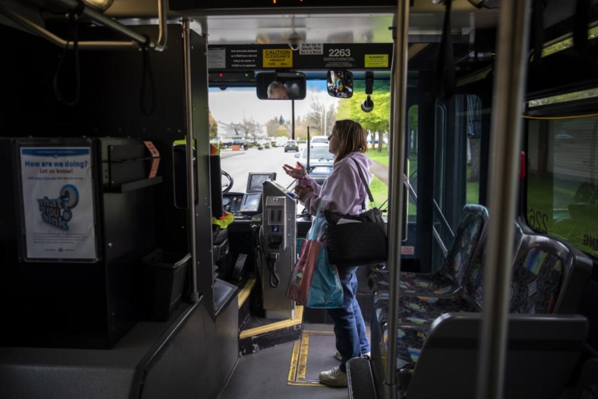 Carolyn Hayden of Vancouver chats with the bus driver as she boards C-Tran’s Route 39 on Thursday. Hayden is a veteran and she said she uses the route often to get to the VA Portland Health Care System Vancouver Campus. She routinely bakes bread for C-Tran staff, but she says she’ll stop if Route 39 is eliminated.