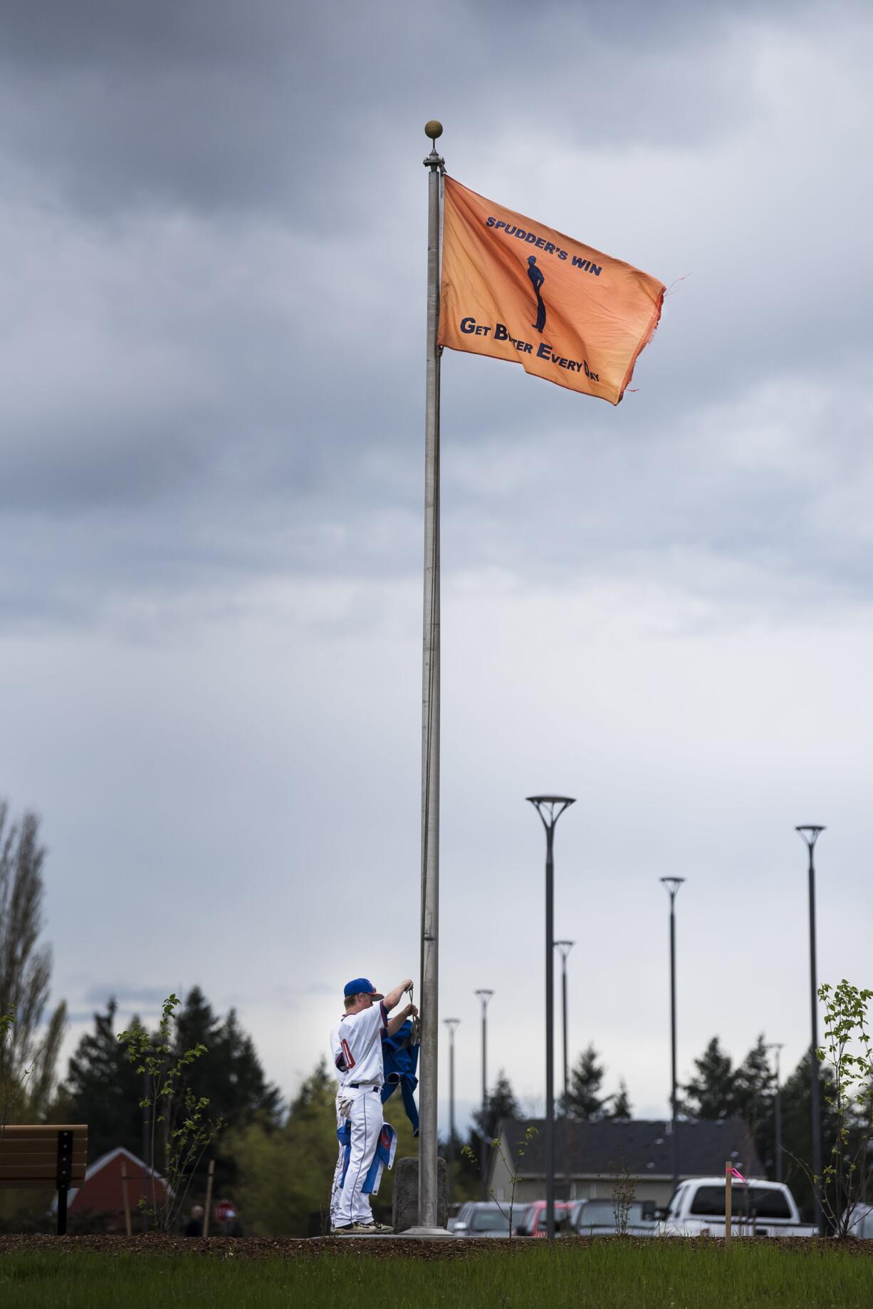 Ridgefield players raise a flag declaring a Spudders’ Victory following their win over Columbia River at the Ridgefield Outdoor Recreation Center on Tuesday night, April 16, 2019.