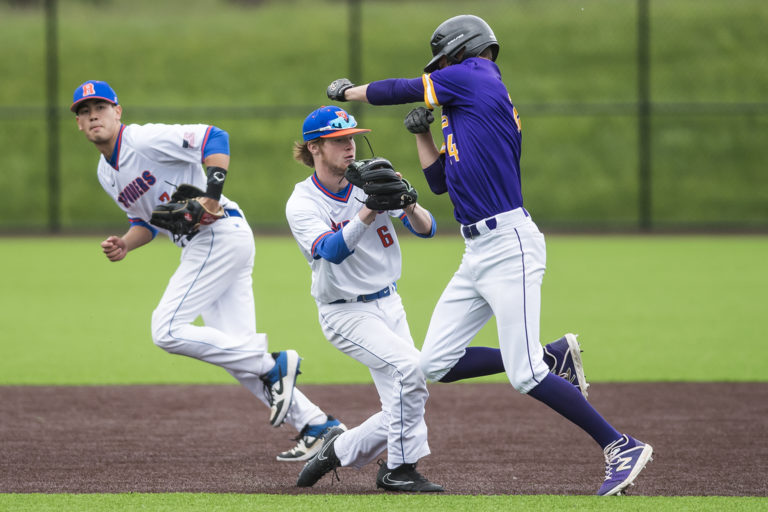 Columbia River's Parker McNeil tries and fails to dodge a tag from Ridgefield's Jimmy Wallace during a game at the Ridgefield Outdoor Recreation Center on Tuesday night, April 16, 2019.