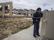 Ed Stanley of the U.S. Postal Service prepares a bank of mailboxes Wednesday at a new Clark County housing development, the Meadows at 58th Street in the Minnehaha area. Clark County’s population growth cycle is continuing at a rate faster than the rest of the Portland metro area.