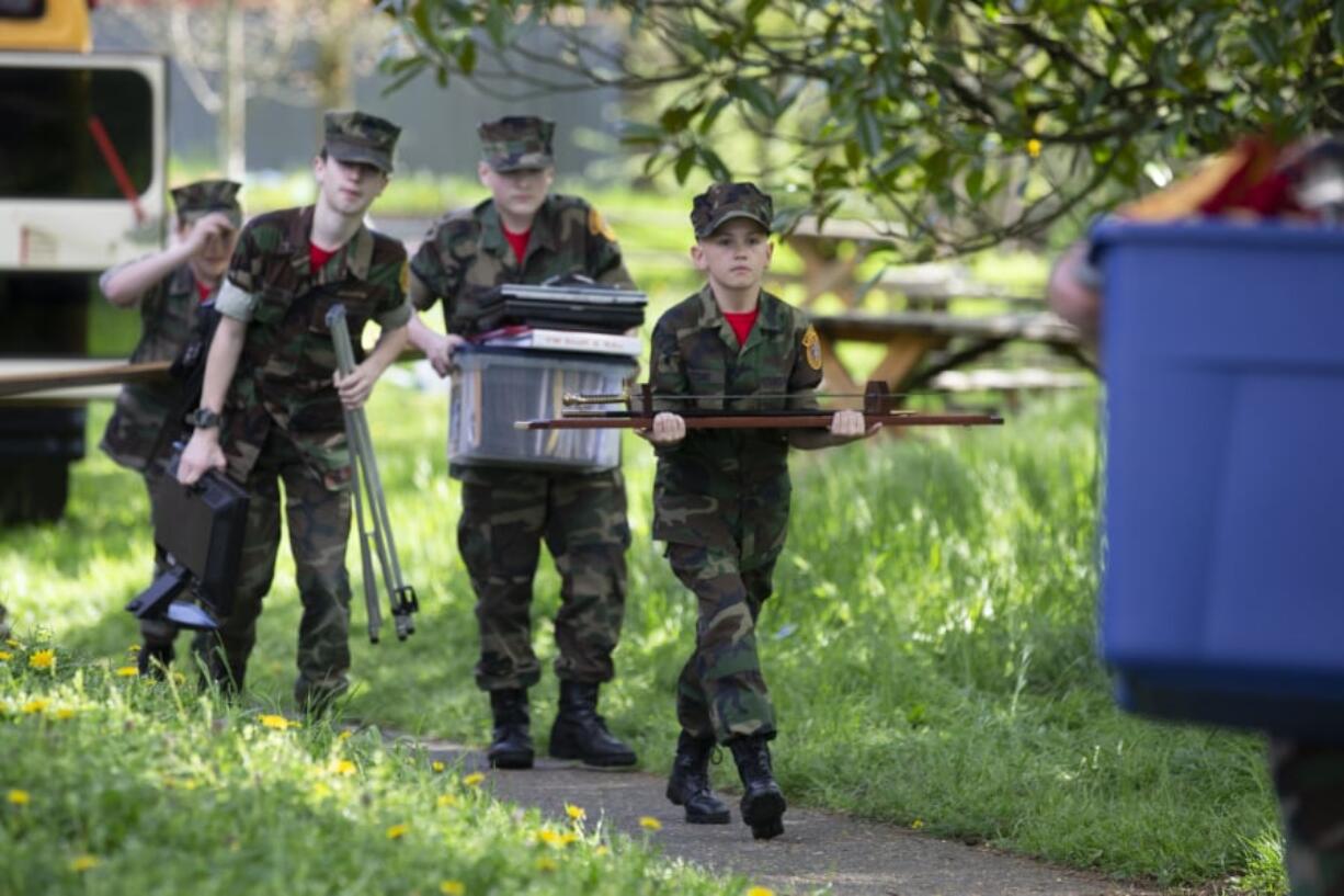 The Lewis & Clark Young Marines, a youth program for boys and girls, spent part of April 20 moving out of its home in the Vancouver Elks Lodge after the Elks raised the organization’s rent and added new restrictions on what space the students could use. Vancouver 11-year-old Joseph Stone carries out a ceremonial sword during the move. Randy L.