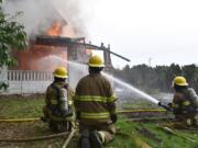 Clark County Fire District 3 firefighters fight a blaze in an empty structure during a training exercise April 15 in Brush Prairie. The district, which responded to 55 local wildfires last year, is preparing for a potentially active, early start to fire season.