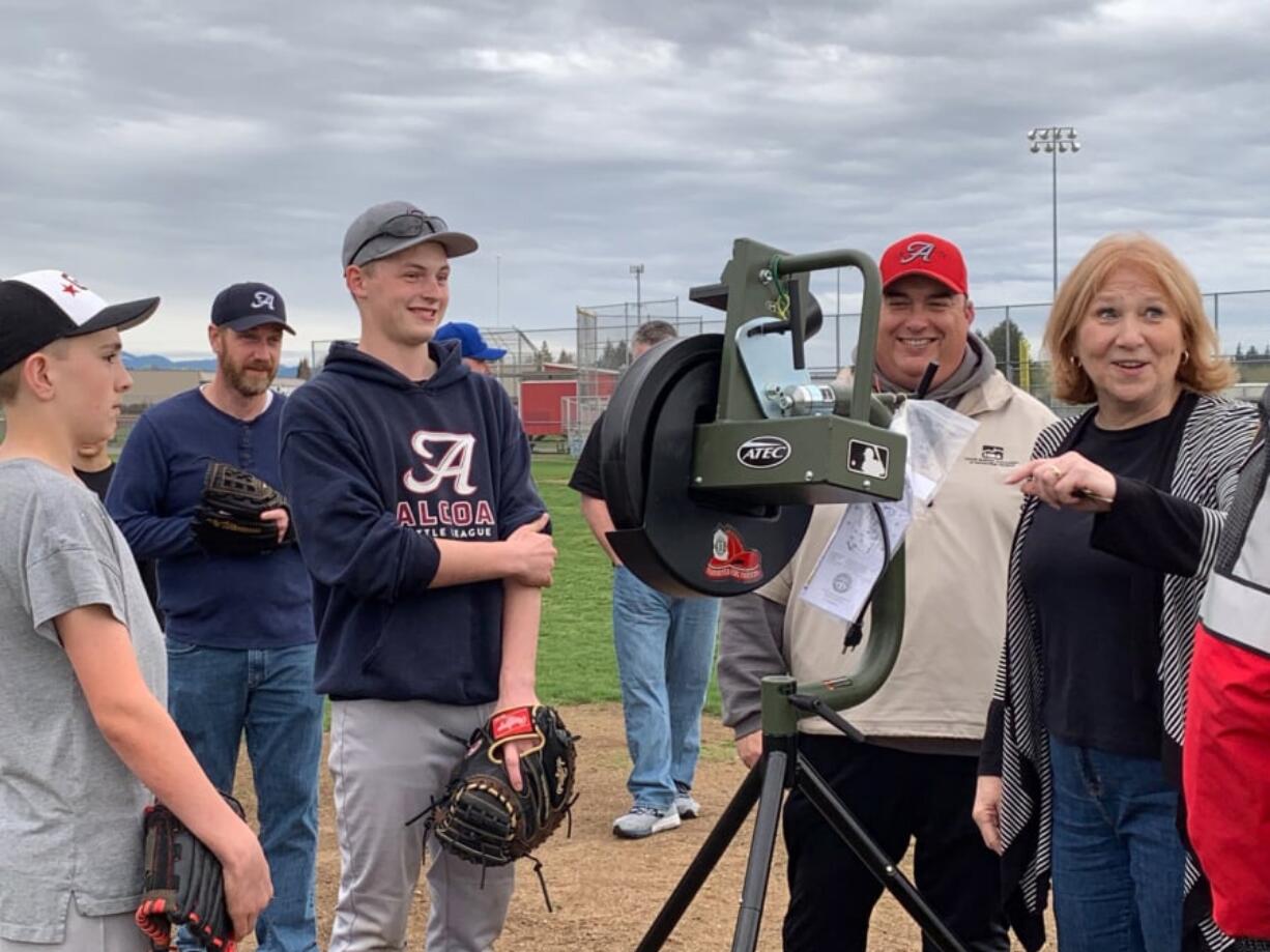 Meadow Homes: Vancouver Mayor Anne McEnerny-Ogle, right, shows off a new pitching machine, which she and the International Association of Fire Fighters local 452 chapter donated to Alcoa Little League. The league lost equipment and mementos in a fire in late March.