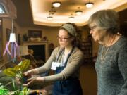 Eldergrow educator Becky Plourde shows resident Fay Holbrook how to move a plant into a small indoor garden at Touchmark at Fairway Village in Vancouver. A University of Washington report in 2014 found that gardening can help reduce the risk factors of dementia and lessen severity of depression for those who are clinically depressed.