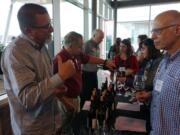 Members of the Southwest Washington Winery Association address attendees at the recent Travel & Words Conference, held at a space under construction at The Waterfront Vancouver. Pictured are Dave Kelly, from left, Richard Meyerhoefer and Joe Leadingham.