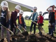 Students from Sifton Elementary School break ground Wednesday on the site of a future elementary school campus during a school assembly in Vancouver.