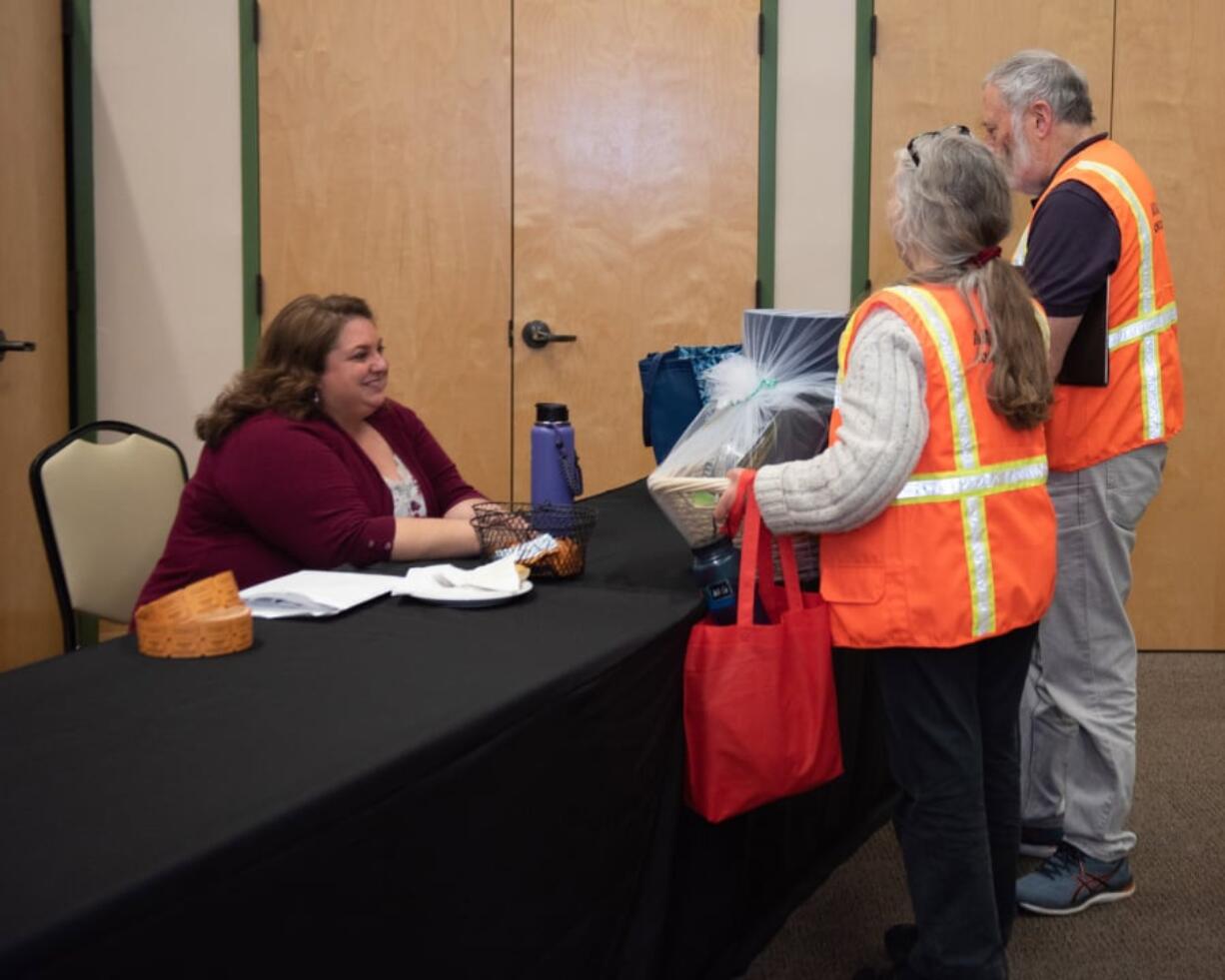 Lianne Martinez, emergency preparedness coordinator at Clark County Public Health, speaks with volunteers at a ceremony Thursday night at St. Joseph Catholic Church’s parish hall.