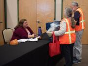 Lianne Martinez, emergency preparedness coordinator at Clark County Public Health, speaks with volunteers at a ceremony Thursday night at St. Joseph Catholic Church’s parish hall.