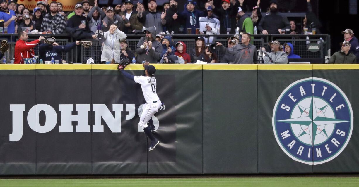 Seattle Mariners center fielder Mallex Smith and fans watch the home run ball of Houston Astros' Jose Altuve in the fifth inning of a baseball game Saturday, April 13, 2019, in Seattle.