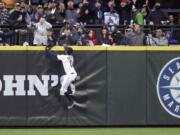 Seattle Mariners center fielder Mallex Smith and fans watch the home run ball of Houston Astros' Jose Altuve in the fifth inning of a baseball game Saturday, April 13, 2019, in Seattle.