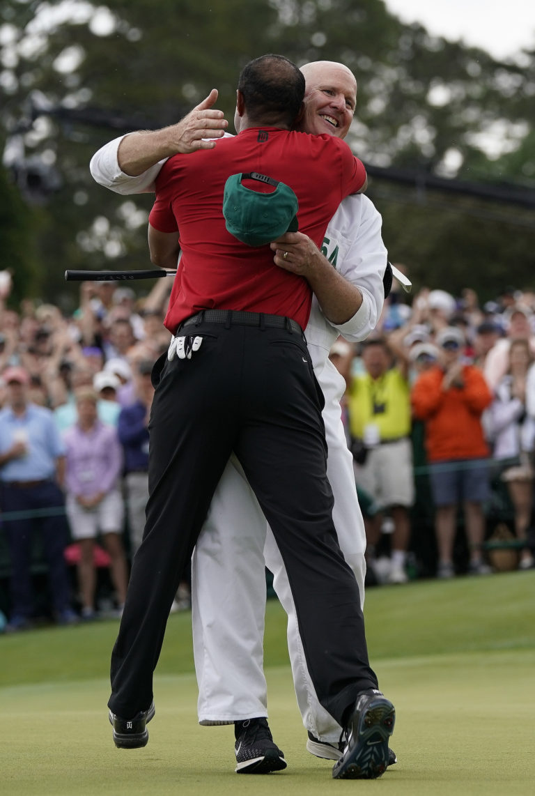 Tiger Woods reacts with his caddie Joe LaCava as he wins the Masters golf tournament Sunday, April 14, 2019, in Augusta, Ga. (AP Photo/David J.