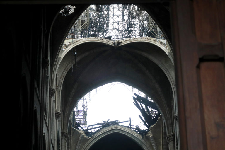 A hole is seen in the dome inside Notre cathedral in Paris, Tuesday, April 16, 2019. Firefighters declared success Tuesday in a more than 12-hour battle to extinguish an inferno engulfing Paris' iconic Notre Dame cathedral that claimed its spire and roof, but spared its bell towers and the purported Crown of Christ.