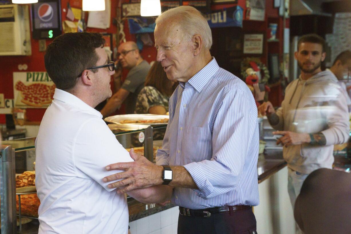 Democratic presidential candidate and former Vice President Joe Biden greets people at Gianni's Pizza, in Wilmington Del., Thursday, April 25, 2019.