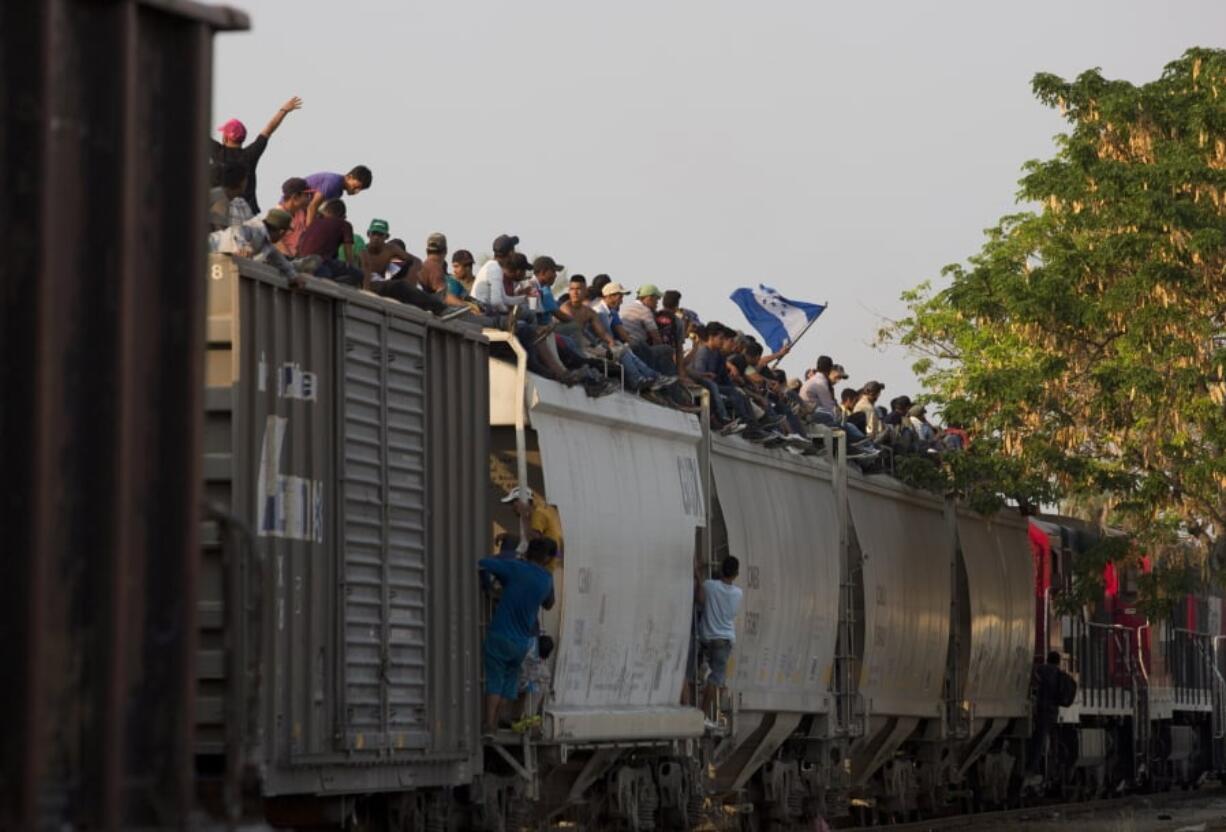 Central American migrants ride atop a freight train during their journey toward the U.S.-Mexico border, in Ixtepec, Oaxaca State, Mexico, Tuesday, April 23, 2019. The once large caravan of about 3,000 people was essentially broken up by an immigration raid on Monday, as migrants fled into the hills, took refuge at shelters and churches or hopped passing freight trains.