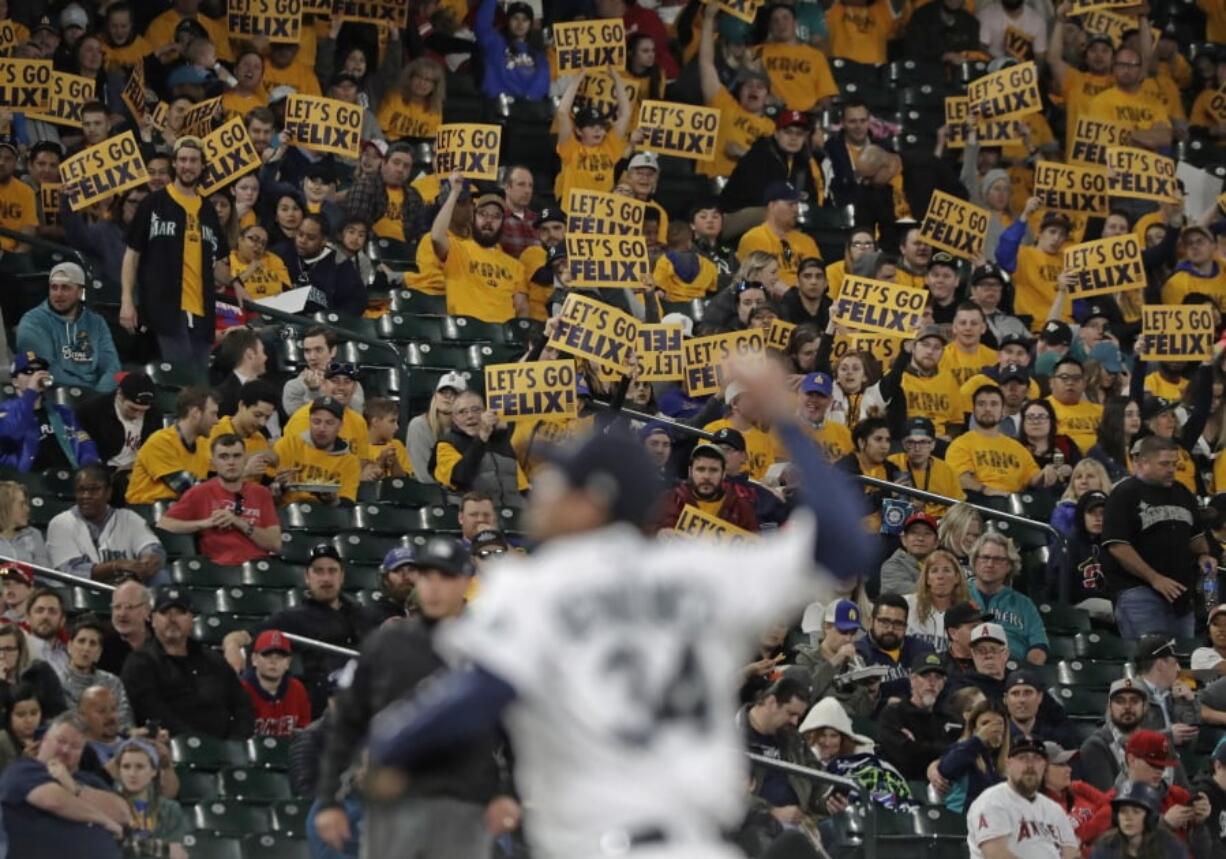 Fans in the “King’s Court” cheering section hold signs as Seattle Mariners starting pitcher Felix Hernandez throws during the fifth inning of a baseball game against the Los Angeles Angels, Monday, April 1, 2019, in Seattle. (AP Photo/Ted S.